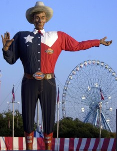 FILE - In this Sept. 27, 2002 file photo, Big Tex welcomes visitors to the Texas State Fair in Dallas. Fire destroyed Big Tex on Friday, Oct. 19, leaving behind little more than the metal frame of the 52-foot-tall metal-and-fabric cowboy that is an icon of the State Fair of Texas. (AP Photo/LM Otero, File)